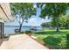Spacious backyard with a concrete patio and lush green lawn by the serene lake at 5114 Leisure Ln, Sherrills Ford, NC 28673