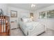 Cozy bedroom with a patterned duvet, neutral walls and a window overlooking a scenic view at 5114 Leisure Ln, Sherrills Ford, NC 28673
