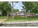 Charming brick waterfront home with large windows and lush, well-maintained lawn at 5114 Leisure Ln, Sherrills Ford, NC 28673