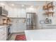 Bright and airy kitchen with white cabinets, stainless steel appliances, and marbled backsplash at 5114 Leisure Ln, Sherrills Ford, NC 28673