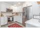 Modern kitchen with white cabinets, stainless steel appliances, marble backsplash and hardwood floors at 5114 Leisure Ln, Sherrills Ford, NC 28673