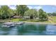 Aerial view of waterfront property with a boat dock and lush, green landscape at 5114 Leisure Ln, Sherrills Ford, NC 28673