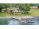 Waterfront view showing a boat dock and a beautifully landscaped yard at 5114 Leisure Ln, Sherrills Ford, NC 28673