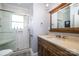 Updated bathroom featuring a glass shower, wood vanity, and modern fixtures, offering a spa-like experience at 524 Hawthorne Ln, Charlotte, NC 28204