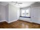 Cozy bedroom featuring a window seat, ceiling fan, and hardwood floors, bathed in natural light at 524 Hawthorne Ln, Charlotte, NC 28204