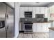 Galley kitchen with stainless appliances, granite counters and white cabinets at 524 Hawthorne Ln, Charlotte, NC 28204