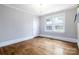 Inviting room with beautiful hardwood floors and ample natural light with views of the neighborhood at 524 Hawthorne Ln, Charlotte, NC 28204