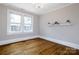Bright room featuring hardwood floors, white trim, and a chandelier, bathed in natural light from large windows at 524 Hawthorne Ln, Charlotte, NC 28204