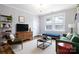 Cozy living room featuring hardwood floors, a modern chandelier, and comfortable seating at 524 Hawthorne Ln, Charlotte, NC 28204