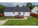 The back of the house features a small deck with seating overlooking the well-maintained backyard and fence at 532 Jedburgh Way, Rock Hill, SC 29730
