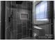 Modern bathroom with glass-enclosed shower, black tiling, and tiled inset shelf at 532 Jedburgh Way, Rock Hill, SC 29730