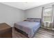 Bedroom with neutral gray walls, window with coverings, and a bed with striped coverings at 532 Jedburgh Way, Rock Hill, SC 29730