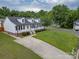 A charming home with a white picket fence, landscaped front yard, and concrete driveway at 532 Jedburgh Way, Rock Hill, SC 29730