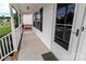 Front porch with white railings and front door with black shutters and storm door at 532 Jedburgh Way, Rock Hill, SC 29730
