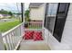 Porch with swing with patterned red and white pillows and the lawn in the background at 532 Jedburgh Way, Rock Hill, SC 29730