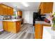 Well-lit kitchen featuring wood cabinets, stainless steel appliances, and a breakfast bar at 532 Jedburgh Way, Rock Hill, SC 29730