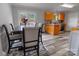 Kitchen dining area featuring natural lighting, kitchen island, stainless appliances, and hardwood floor at 532 Jedburgh Way, Rock Hill, SC 29730