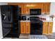 Kitchen with black appliances, wood cabinets, and modern countertops at 532 Jedburgh Way, Rock Hill, SC 29730