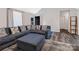 Comfortable living room area with stylish sectional sofa, ottoman and wood-look floors at 532 Jedburgh Way, Rock Hill, SC 29730
