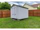 Fenced backyard with grass, a wooden shed and a view of neighboring house at 532 Jedburgh Way, Rock Hill, SC 29730