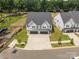 Aerial view of a modern home with a three-car garage and professionally landscaped front yard at 6032 Corbin Woods Ct, Charlotte, NC 28226
