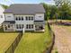 Backyard aerial view highlighting the manicured lawn and covered patio of this modern two story home at 6032 Corbin Woods Ct, Charlotte, NC 28226