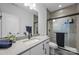 Elegant bathroom with a white vanity, quartz countertop, modern fixtures, and tiled walk-in shower at 6032 Corbin Woods Ct, Charlotte, NC 28226