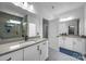 Bright bathroom with double vanity, neutral countertops, large mirrors, and a glass-enclosed shower at 6032 Corbin Woods Ct, Charlotte, NC 28226