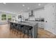 Spacious kitchen with white cabinets, a large island, and stainless steel appliances at 6032 Corbin Woods Ct, Charlotte, NC 28226
