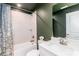 Stylish bathroom featuring a shower-over-tub, a modern vanity, and green accent walls at 628 Uwharrie River Rd, Charlotte, NC 28211