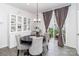Cozy dining room features stylish chairs, a modern light fixture, and sliding door to the outside patio at 628 Uwharrie River Rd, Charlotte, NC 28211