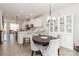 Open-concept dining area with modern decor, a dark wood table, and seamless connection to the kitchen at 628 Uwharrie River Rd, Charlotte, NC 28211