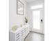Bright entryway featuring a frosted glass door, stylish cabinet with decor, and wood-look floors at 628 Uwharrie River Rd, Charlotte, NC 28211