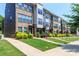 Charming street view of modern townhomes with well-kept lawns and landscaped front yards on a sunny day at 628 Uwharrie River Rd, Charlotte, NC 28211