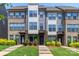 Beautiful townhome exterior featuring brick accents, modern siding, lush landscaping, and a well-manicured lawn at 628 Uwharrie River Rd, Charlotte, NC 28211