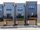 Row of townhomes, each with balcony, garage, and mini-split air conditioners at 628 Uwharrie River Rd, Charlotte, NC 28211