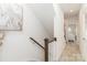 Upstairs hallway with carpet and view into a bedroom with neutral colors and lots of natural light at 628 Uwharrie River Rd, Charlotte, NC 28211