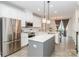 Modern kitchen with white cabinetry, stainless steel appliances, and a view of the dining area at 628 Uwharrie River Rd, Charlotte, NC 28211