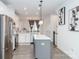 Spacious kitchen with stainless steel appliances, white cabinets, and an open view of the dining area at 628 Uwharrie River Rd, Charlotte, NC 28211