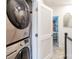 Convenient upstairs laundry area with a stacked washer and dryer unit and access to a bedroom at 628 Uwharrie River Rd, Charlotte, NC 28211
