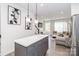 Inviting living area with a comfortable sofa, open to the kitchen with modern pendant lighting at 628 Uwharrie River Rd, Charlotte, NC 28211