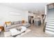 Open floor plan with a living room, kitchen and staircase with modern gray and white design elements at 628 Uwharrie River Rd, Charlotte, NC 28211