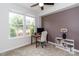 Comfortable home office with a large window for natural light, a desk, and neutral walls and carpet at 628 Uwharrie River Rd, Charlotte, NC 28211