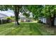 Large backyard with a shed and trees providing ample shade at 639 S Eastway Dr, Troutman, NC 28166