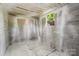 Unfinished basement showcasing concrete block walls, a painted ceiling, and a small window at 639 S Eastway Dr, Troutman, NC 28166