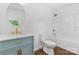 Bathroom features modern vanity with marble top, round mirror and shower and tub combo at 639 S Eastway Dr, Troutman, NC 28166