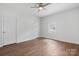 Bedroom with wood floors features neutral paint, a ceiling fan, and natural light at 639 S Eastway Dr, Troutman, NC 28166