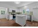 Charming kitchen features an island, stainless steel appliances and ample cabinet space at 639 S Eastway Dr, Troutman, NC 28166