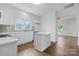 Charming kitchen features an island, stainless steel appliances, and opens to the living room at 639 S Eastway Dr, Troutman, NC 28166