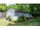 Backyard shed with storage space surrounded by plants at 639 S Eastway Dr, Troutman, NC 28166